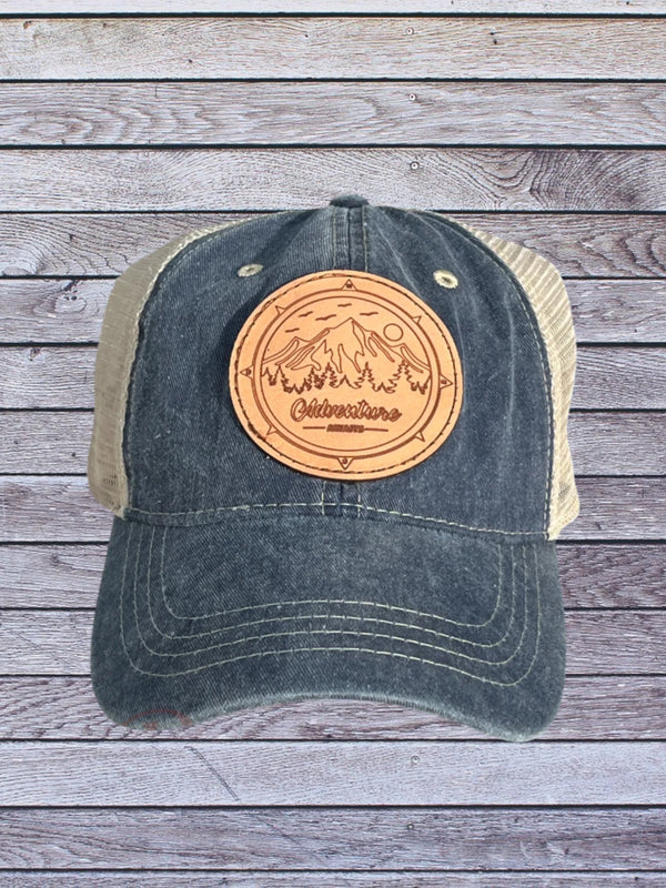 Ball cap with camping themed leather hat patch